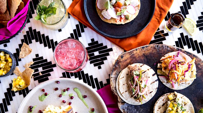 A tableful of food and cocktails from Chido + Padre's. PHOTO BY HEIDI GELDHAUSER
