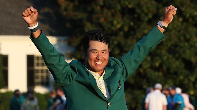 Hideki Matsuyama sports the green jacket in victory after winning the Masters by one stroke on Sunday, April 11, 2021, at August National Golf Club in Augusta. “Curtis Compton / Curtis.Compton@ajc.com”