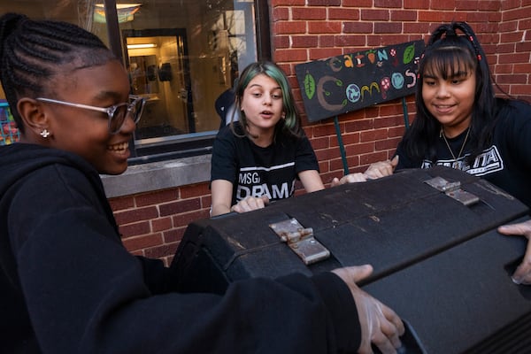 Marietta Middle School seventh graders Yadajah Gresham (left), Addelynn Covingtree (center) and Elissa Ramirez participate in the Compost Connectors program on Monday, Nov. 17, 2025. (Olivia Bowdoin for the AJC)