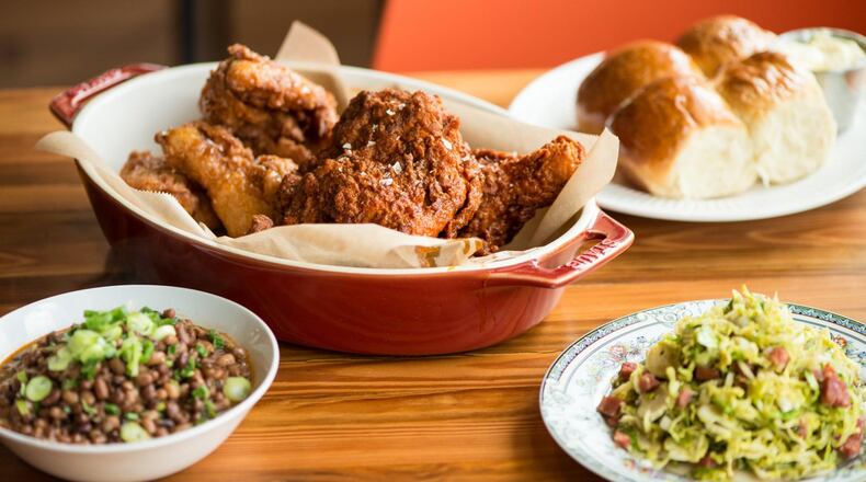 Mary Hoopa’s whole fried chicken, half spicy, half sweet, with sides of rolls, Sea Island red peas, and Brussels sprouts. CONTRIBUTED BY MIA YAKEL