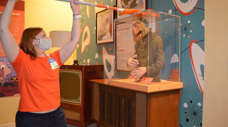 Jill Nash Malool, museum director at the Center for Puppetry Arts, helps sanitize exhibits at the museum, which opens to the public July 10. The center still won’t be bringing audiences into its theater, but it is livestreaming performances for an online audience. CONTRIBUTED: CENTER FOR PUPPETRY ARTS