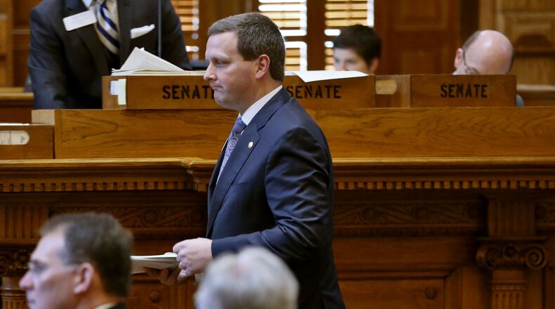 March 31, 2015 - Atlanta - Sen. Charlie Bethel, R-Dalton, heads to the well to present House Bill 429, which provides a mandate to guarantee insurance coverage of young children with autism. The bill unanimously passed. BOB ANDRES / BANDRES@AJC.COM