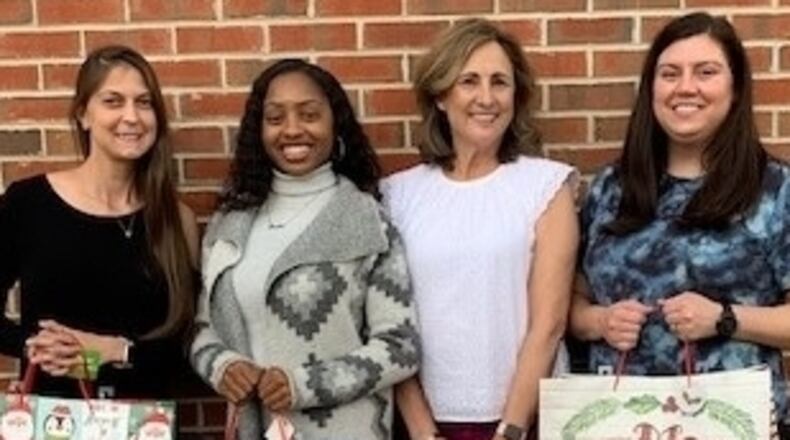 Adopt-A-Senior program is held each holiday season by the Cherokee County Senior Services. Donated gift bags are delivered to the CCSS clients. (Pictured: Leslie White, Jasmine McKinney, HDM Supervisor/Volunteer Coordinator Alice O Micham and Brittany Kiser.