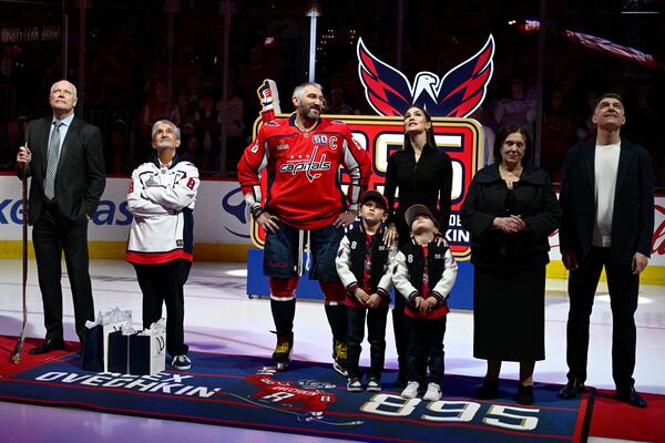 Washington Capitals left wing Alex Ovechkin (8) takes part in a ceremony to honor him for scoring 895 career NHL goals before an NHL hockey game against the Carolina Hurricanes, Thursday, April 10, 2025, in Washington. (AP Photo/Nick Wass)