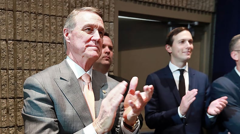 U.S. Sen. David Perdue applauds President Donald Trump during his speech at the Black Voices for Trump Coalition Rollout in November in Atlanta.