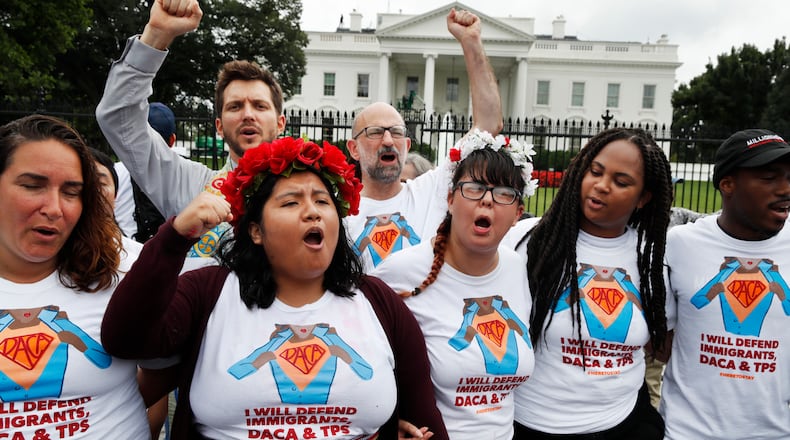 Wendolynn Perez, 23, second from left, a DACA recipient who is now a permanent resident and is originally from Peru, chants with other supporters of immigration reform, Tuesday, Aug. 15, 2017, at the White House in Washington. The protesters want to preserve the Obama administration program known as Deferred Action for Childhood Arrivals, or DACA. The Trump administration has said it still has not decided the program's fate.(AP Photo/Jacquelyn Martin)