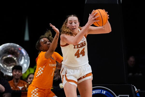 Texas forward Taylor Jones (44)pulls down a rebound against Tennessee guard Samara Spencer (7) during the first half in the Sweet 16 of the NCAA college basketball tournament, Saturday, March 29, 2025. in Birmingham, Ala. (AP Photo/Gerald Herbert)