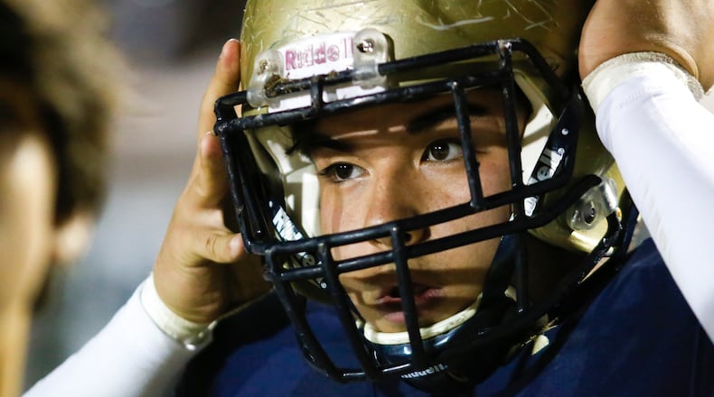 Dacula's Dylan Parr (5) puts on his helmet during the first half of a 2019 game. (Casey Sykes/Special)