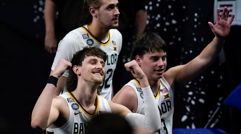 Baylor guard Matthew Mayer, left, celebrates as he walks off the court at the end of a men's Final Four NCAA college basketball tournament semifinal game against Houston, Saturday, April 3, 2021, at Lucas Oil Stadium in Indianapolis. Baylor won 78-59. (AP Photo/Darron Cummings)