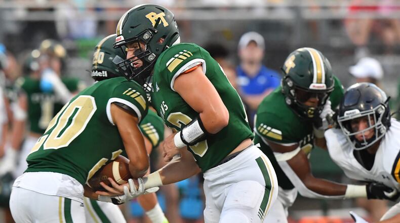 August 27, 2021 Roswell - Blessed Trinity's QB JC French (13) makes a handoff to Blessed Trinity's Evan Dickens (20) in the first half at Blessed Trinity Catholic High School in Roswell on Friday, August 27, 2021. (Hyosub Shin / Hyosub.Shin@ajc.com)