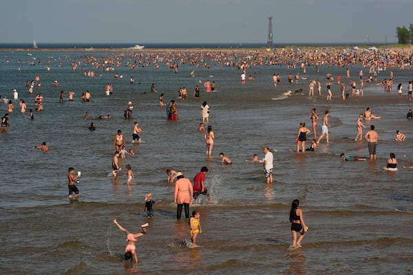 Beach goers crowd a public beach on the Lake Michigan shore, Sunday, June 22, 2025, in Chicago. (AP Photo/Kiichiro Sato)