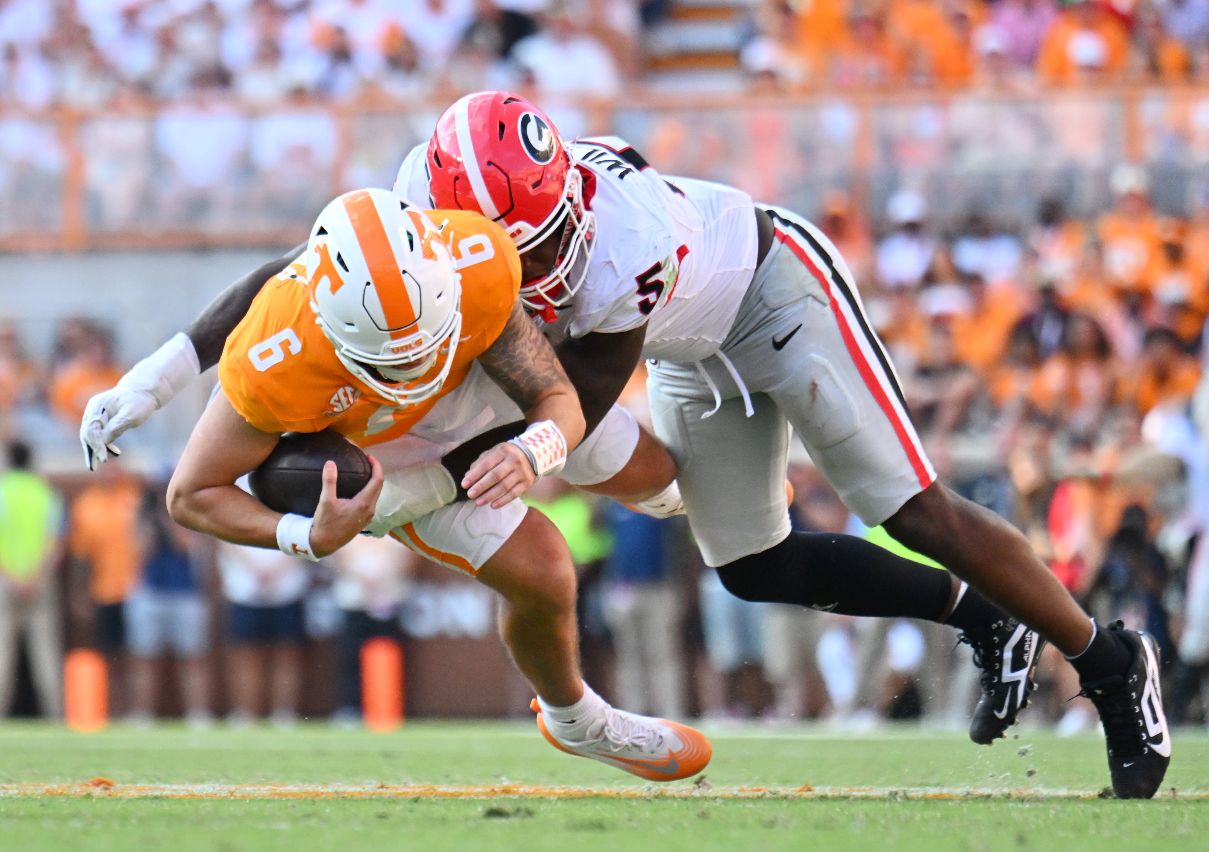 Tennessee quarterback Joey Aguilar (left) is sacked by Georgia linebacker Raylen Wilson during the second half at Neyland Stadium on Saturday, Sept. 13, 2025, in Knoxville, Tenn. (Hyosub Shin/AJC)