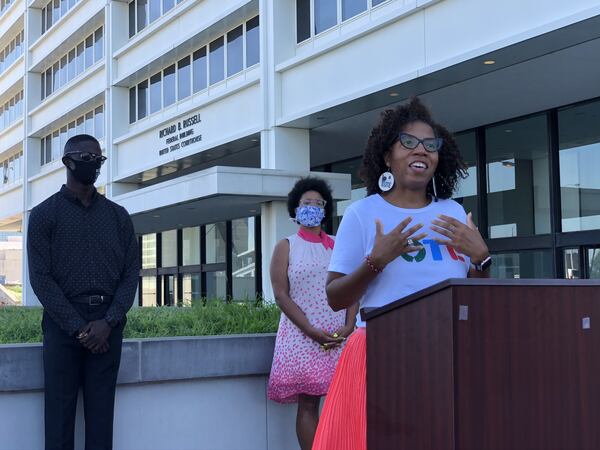 Wanda Mosley of Black Voters Matter speaks Tuesday outside the Richard Russell B. Federal Building in Atlanta about a lawsuit seeking changes to elections to the Georgia Public Service Commission. Mosley is surrounded by other plaintiffs in the lawsuit, Georgia NAACP President James Woodall and Briont McCorkle of Georgia Conservation Voters. MARK NIESSE / MARK.NIESSE@AJC.COM