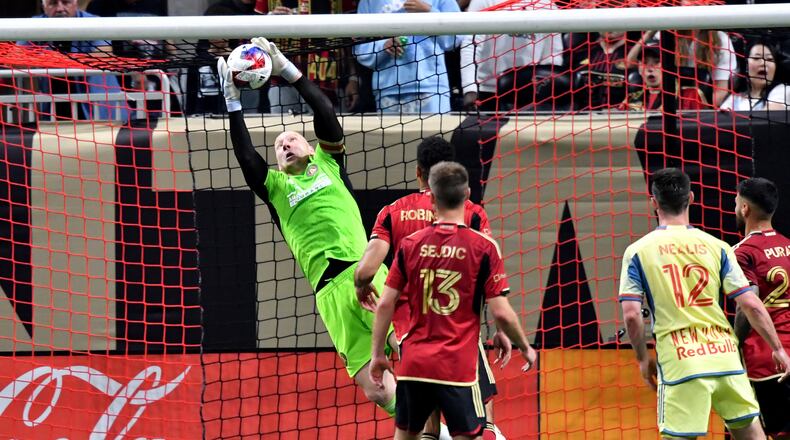 Atlanta United's goalkeeper Brad Guzan (left) grabs a shot during the second half in a MLS soccer match at Mercedes-Benz Stadium, Saturday, April 1, 2023, in Atlanta. Atlanta United won 1-0 over New York Red Bulls. (Hyosub Shin / Hyosub.Shin@ajc.com)