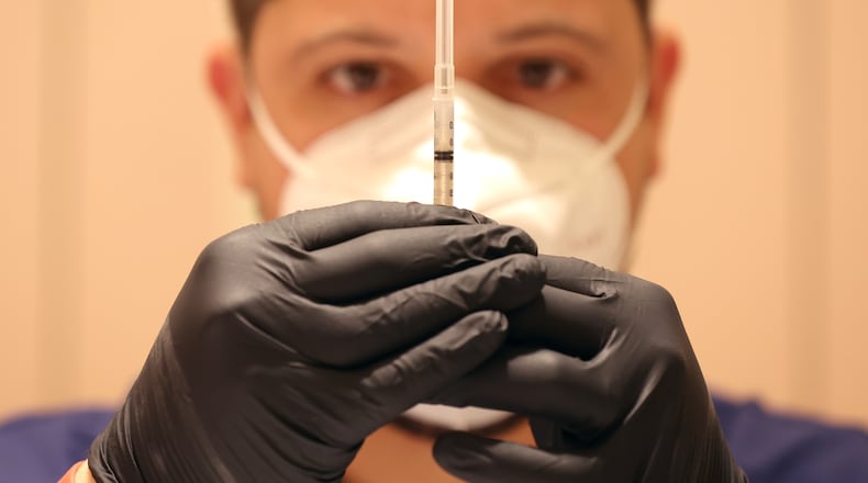 Jatniel Hernandez fills syringes with COVID-19 vaccine booster shots, at a COVID-19 vaccination clinic, on April 6, 2022, in San Rafael, California. (Justin Sullivan/Getty Images/TNS)