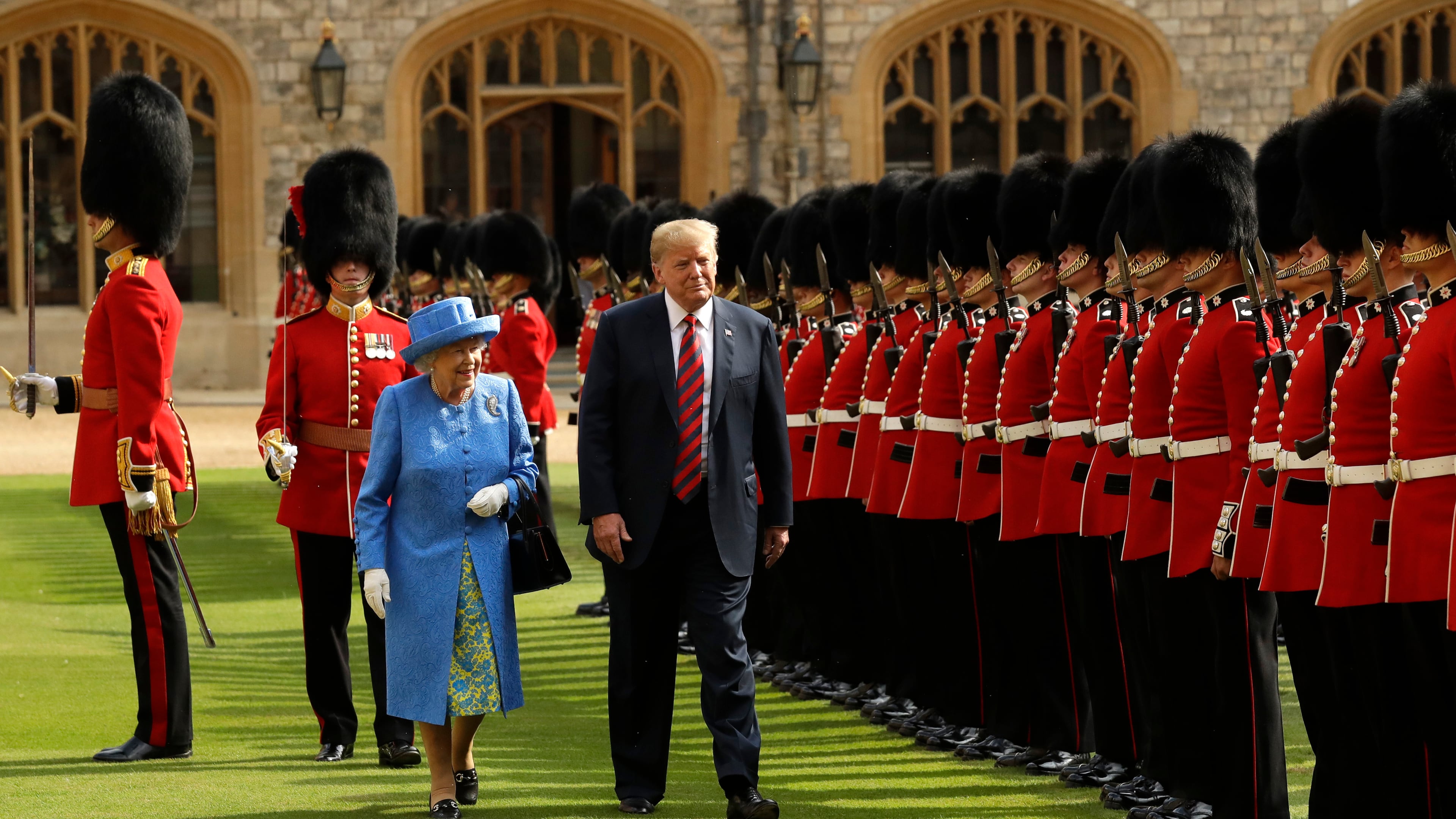 FILE - U.S. President Donald Trump and Britain's Queen Elizabeth II inspect a Guard of Honour, formed of the Coldstream Guards at Windsor Castle in Windsor, England, July 13, 2018.(AP Photo/Matt Dunham, Pool, File)
