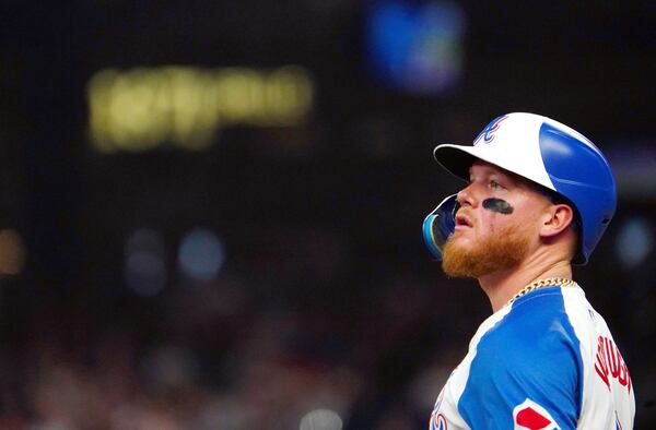 Atlanta Braves outfielder Alex Verdugo looks to the scoreboard as he waits on third base during the third inning of a baseball game against the Minnesota Twins, Saturday, April 19, 2025, in Atlanta. (AP Photo/ John David Mercer)