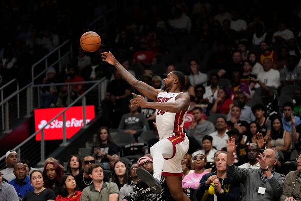 Miami Heat forward Haywood Highsmith (24) keeps the ball in bounds in the first half of an NBA play-in tournament basketball game against the Atlanta Hawks, Friday, April 18, 2025, in Atlanta. (AP Photo/Brynn Anderson)