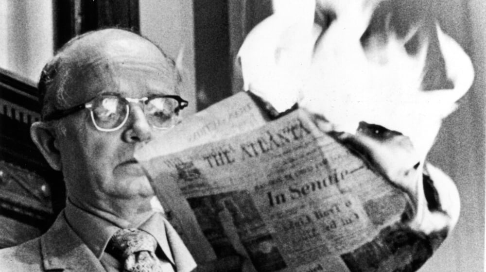 Georgia Lt. Gov. Lester Maddox, angry about an article, burns a copy of The Atlanta Constitution in the state Senate on March 10, 1971, saying the paper did not have the "guts, integrity, manhood or decency" to report the situation accurately. (AJC file)