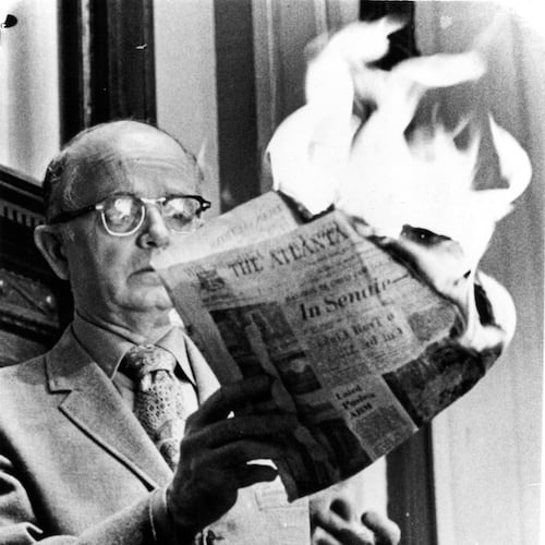 Georgia Lt. Gov. Lester Maddox, angry about an article, burns a copy of The Atlanta Constitution in the state Senate on March 10, 1971, saying the paper did not have the "guts, integrity, manhood or decency" to report the situation accurately. (AJC file)