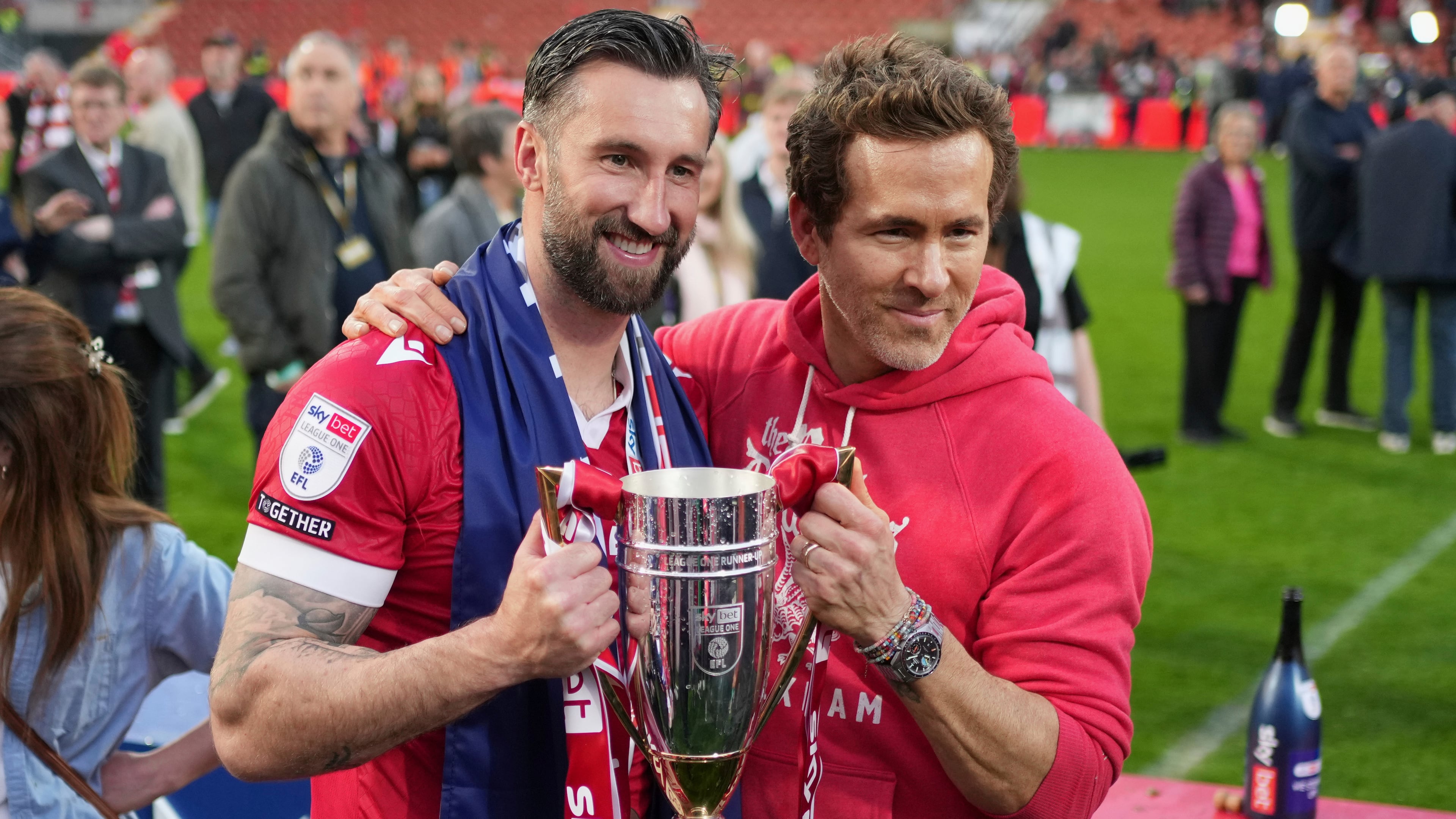 FILE - Wrexham co-owner Ryan Reynolds, right, and Wrexham's Ollie Palmer pose with trophy at the end of the English League One soccer match between Wrexham and Charlton Athletic at the Racecourse ground in Wrexham, Wales, April 26, 2025. (AP Photo/Jon Super, File)