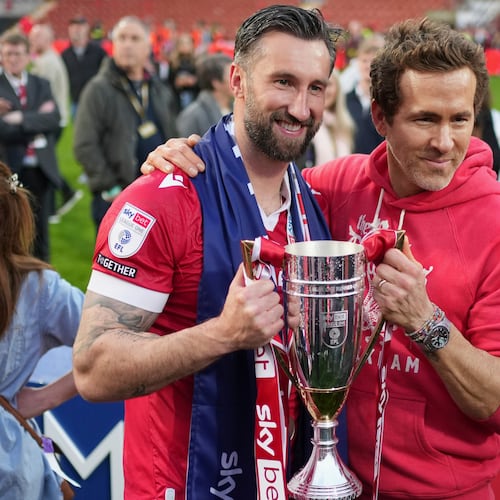 FILE - Wrexham co-owner Ryan Reynolds, right, and Wrexham's Ollie Palmer pose with trophy at the end of the English League One soccer match between Wrexham and Charlton Athletic at the Racecourse ground in Wrexham, Wales, April 26, 2025. (AP Photo/Jon Super, File)