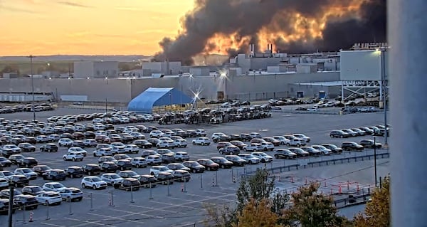 A Kentucky Department of Transportation camera captured a plume of smoke rising above Louisville International Airport on Tuesday. UPS Flight 2976 crashed after taking off, the FAA confirmed. (Screen grab of a Kentucky Department of Transportation traffic camera)