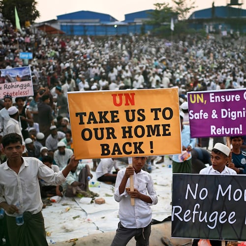 FILE- Rohingya refugee children carry banners during a visit by U.N. Secretary-General António Guterres at the Ukhiya camp in Cox's Bazar, in Bangladesh, March 14, 2025. (AP Photo/Mahmud Hossain Opu, File)