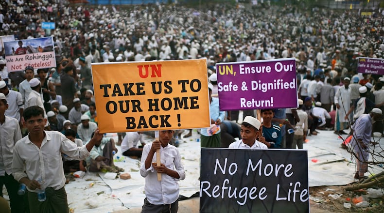FILE- Rohingya refugee children carry banners during a visit by U.N. Secretary-General António Guterres at the Ukhiya camp in Cox's Bazar, in Bangladesh, March 14, 2025. (AP Photo/Mahmud Hossain Opu, File)