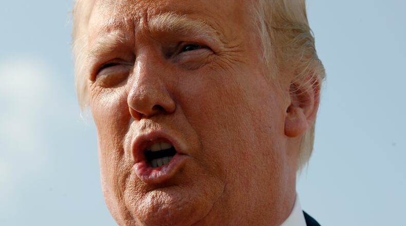 President Donald Trump speaks to the press before boarding Air Force One en route to Mount Rushmore.