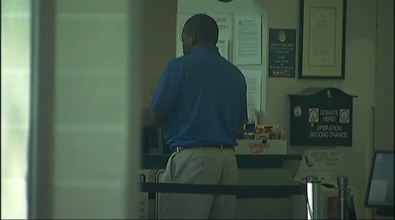 Recardo Wimbush, a former Georgia Tech football star, turns himself into Gwinnett County jail on charges of false imprisonment and cruelty to children.