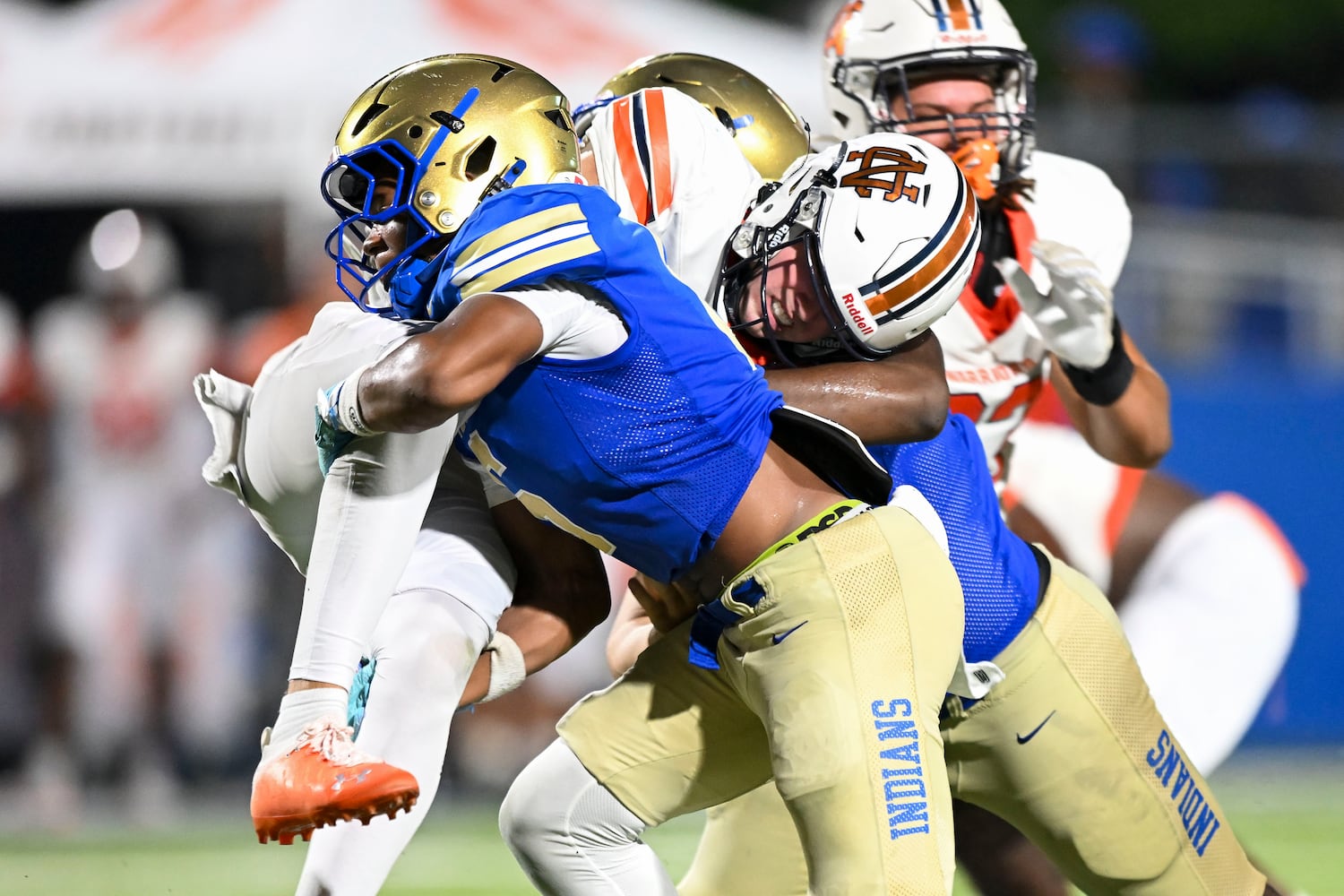 McEachern’s Casey Barner (6) and Praylend Williams (11) wrap North Cobb quarterback Teddy Jarrard (2) up in a tackle during the second half of play Friday, August 22, 2025 at McEachern.  (Daniel Varnado/For the Atlanta Journal-Constitution)