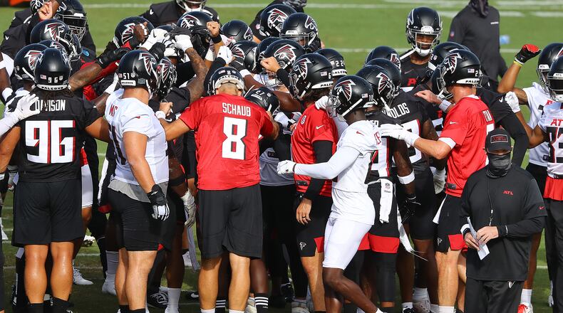 Falcons head coach Dan Quinn (bottom right) and his team take the field for training camp on Thursday, Aug. 27, 2020, in Flowery Branch.