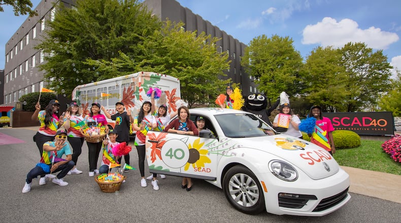 SCAD President and Founder Paula Wallace and student ambassadors celebrate the university’s 40th anniversary on SCAD Day —an open house for hundreds of prospective students from around the world. The VW Bug pictured here was designed by SCAD graduate Emily Isabella (B.F.A., fibers, 2008).