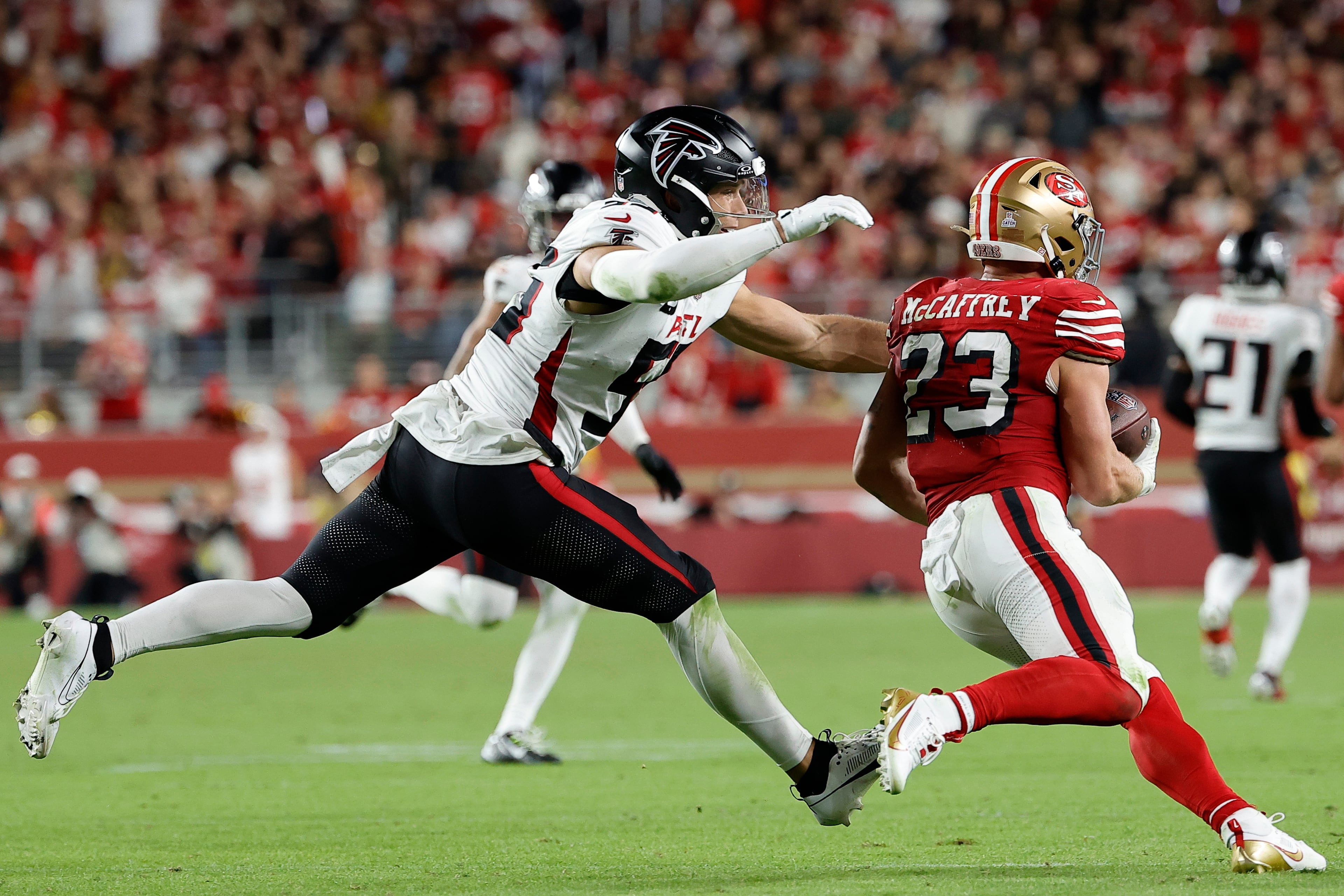 San Francisco 49ers running back Christian McCaffrey (right) runs against Atlanta Falcons linebacker Kaden Elliss on Sunday, Oct. 19, 2025, in Santa Clara, Calif. (Kelley L Cox/AP)