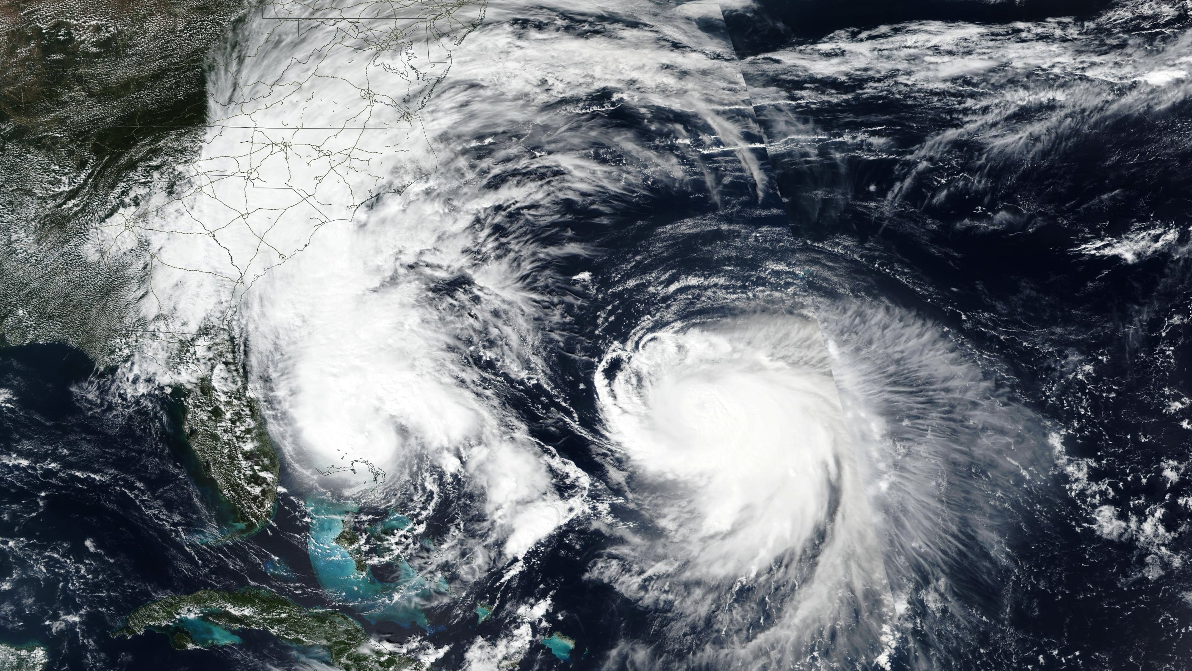This Monday, Sept. 29, 2025, satellite image released by NASA shows Tropical Storm Imelda, left, and Hurricane Humberto in the Atlantic Ocean. (NASA Worldview, Earth Observing System Data and Information System (EOSDIS) via AP)