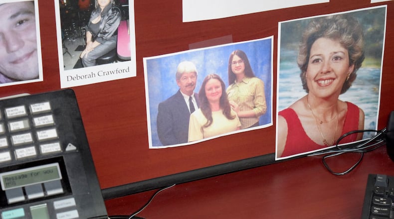 Lt. Mike Hill keeps a photo of Regan Wheeler on his desk at the Paulding County Sheriff’s Office, along with victims of other unsolved homicides. (Photo: Alexis Stevens/astevens@ajc.com)