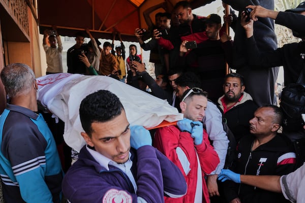Mourners carry the bodies of 8 Red Crescent emergency responders, recovered in Rafah a week after an Israeli attack, as they are transported for burial from a hospital in Deir al-Balah, Gaza Strip, on Monday, March 31, 2025. (AP Photo/Abdel Kareem Hana)