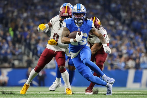 FILE - Detroit Lions running back Jahmyr Gibbs (26) runs past Washington Commanders cornerback Mike Sainristil (0) during the first half of an NFL football divisional playoff game, Saturday, Jan. 18, 2025, in Detroit. (AP Photo/Rey Del Rio, File)