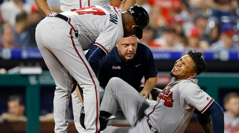 Braves' Johan Camargo reacts after an injury during the fourth inning of the team's baseball game against the Philadelphia Phillies, Wednesday, Sept. 11, 2019, in Philadelphia. (AP Photo/Matt Slocum)