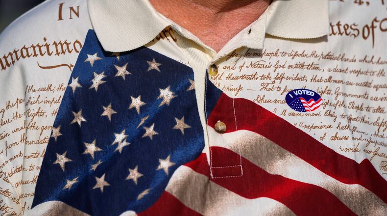 FILE - A man wears an "I voted" sticker on his shirt, printed with the American flag and the U.S. constitution, after voting at Wa-Ke Hatchee Recreation Center in Fort Myers, Fla, on Election Day, Nov. 8, 2022. (AP Photo/Rebecca Blackwell, File)
