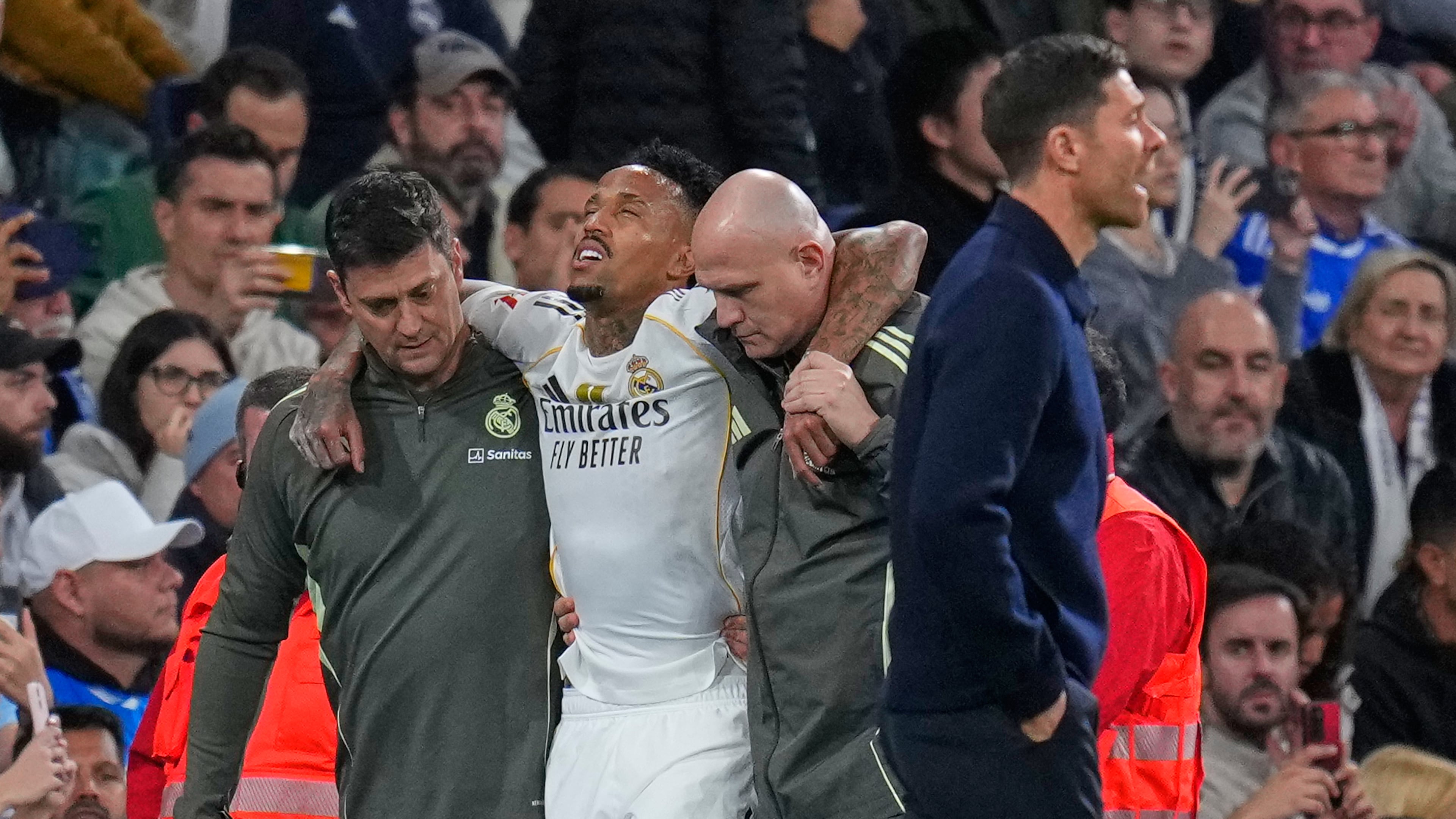 Real Madrid's Eder Militao is assisted from the pitch after getting an injury during the Spanish La Liga soccer match between Real Madrid and Celta Vigo in Madrid, Spain, Sunday, Dec. 7, 2025. (AP Photo/Manu Fernandez)