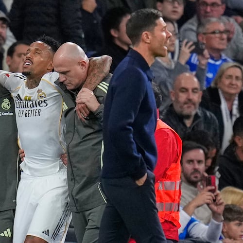 Real Madrid's Eder Militao is assisted from the pitch after getting an injury during the Spanish La Liga soccer match between Real Madrid and Celta Vigo in Madrid, Spain, Sunday, Dec. 7, 2025. (AP Photo/Manu Fernandez)