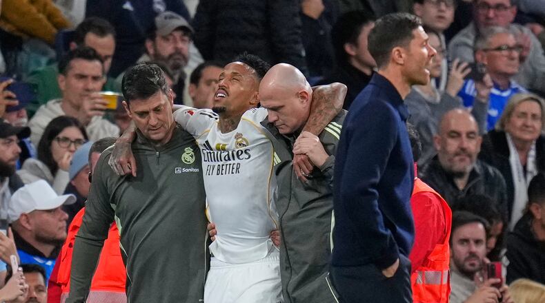 Real Madrid's Eder Militao is assisted from the pitch after getting an injury during the Spanish La Liga soccer match between Real Madrid and Celta Vigo in Madrid, Spain, Sunday, Dec. 7, 2025. (AP Photo/Manu Fernandez)