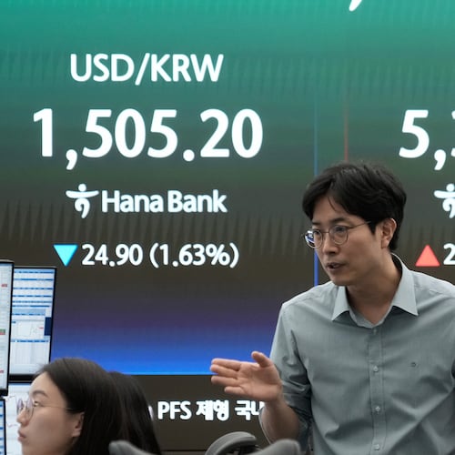 A currency trader reacts near a screen showing the Korea Composite Stock Price Index (KOSPI), right, and the foreign exchange rate between U.S. dollar and South Korean won at the foreign exchange dealing room of the Hana Bank headquarters in Seoul, South Korea, Wednesday, April 1, 2026. (AP Photo/Ahn Young-joon)