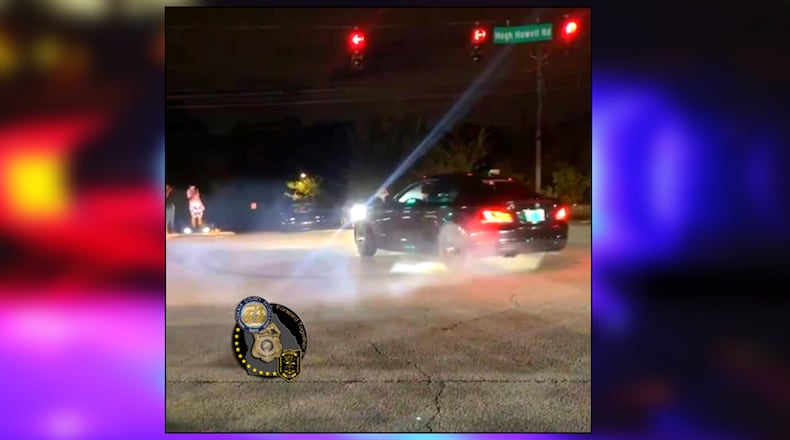 A street racer burns out during an intersection takeover in DeKalb County.