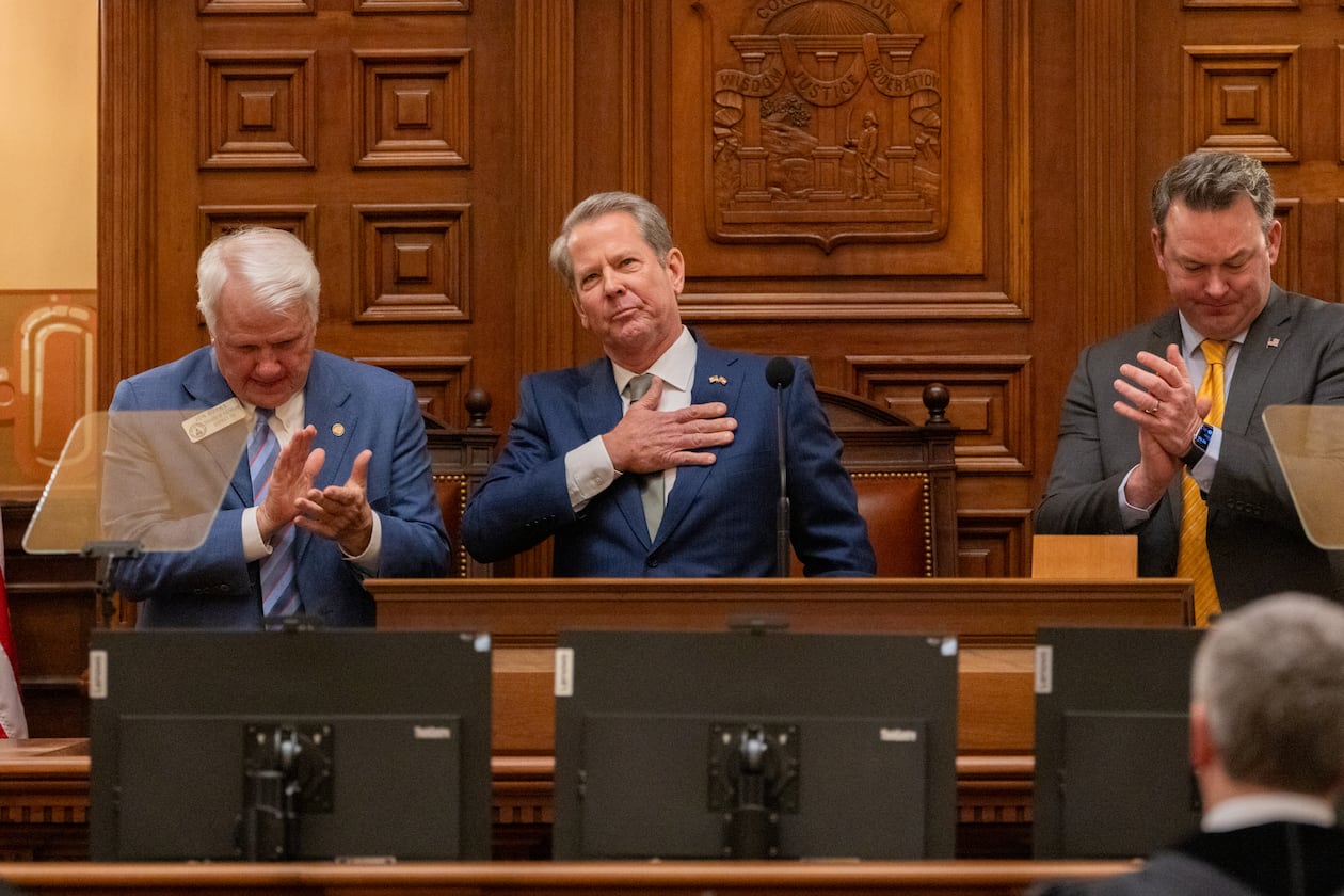 Gov. Brian Kemp, between Speaker Jon Burns and Lt. Gov. Burt Jones, waves after his final State of the State speech in the House of Representatives at the Capitol in Atlanta on Thursday, Jan. 15, 2026. (Arvin Temkar/AJC)