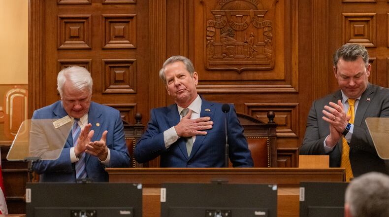 Gov. Brian Kemp, between Speaker Jon Burns and Lt. Gov. Burt Jones, waves after his final State of the State speech in the House of Representatives at the Capitol in Atlanta on Thursday, Jan. 15, 2026. (Arvin Temkar/AJC)