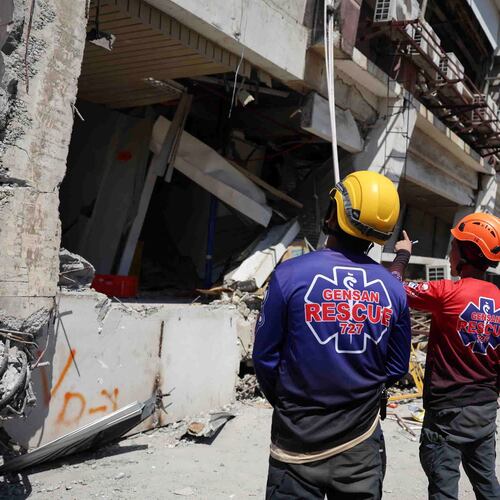 Rescuers inspect a damaged building following an earhtquake in General Santos, Philippines Tuesday, June 9, 2026. (AP Photo/Basilio Sepe)