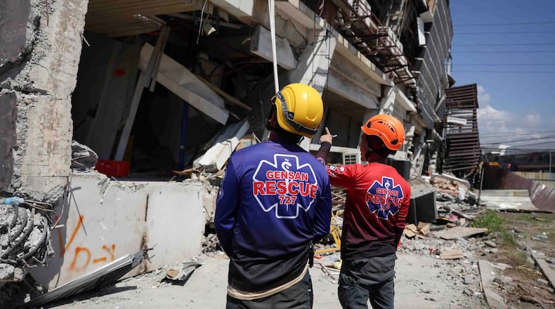 Rescuers inspect a damaged building following an earhtquake in General Santos, Philippines Tuesday, June 9, 2026. (AP Photo/Basilio Sepe)